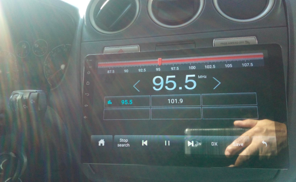 Reviewer&#x27;s picture of the car stereo with large digital screen attached to their car dashboard 