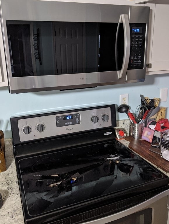 Microwave above a shattered stove top