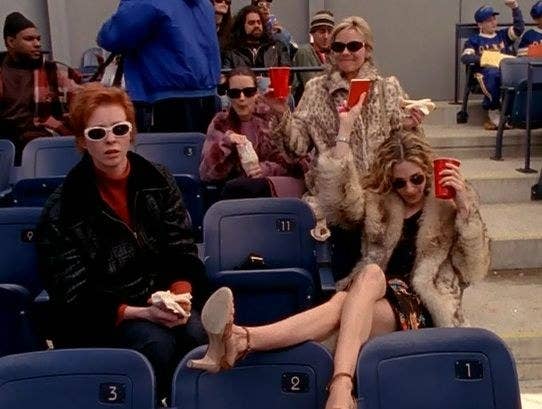 Carrie, Miranda, Charlotte, and Samantha drinking at a baseball game
