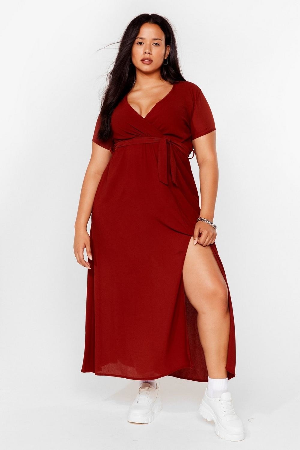 model wearing red V-neck dress with slit