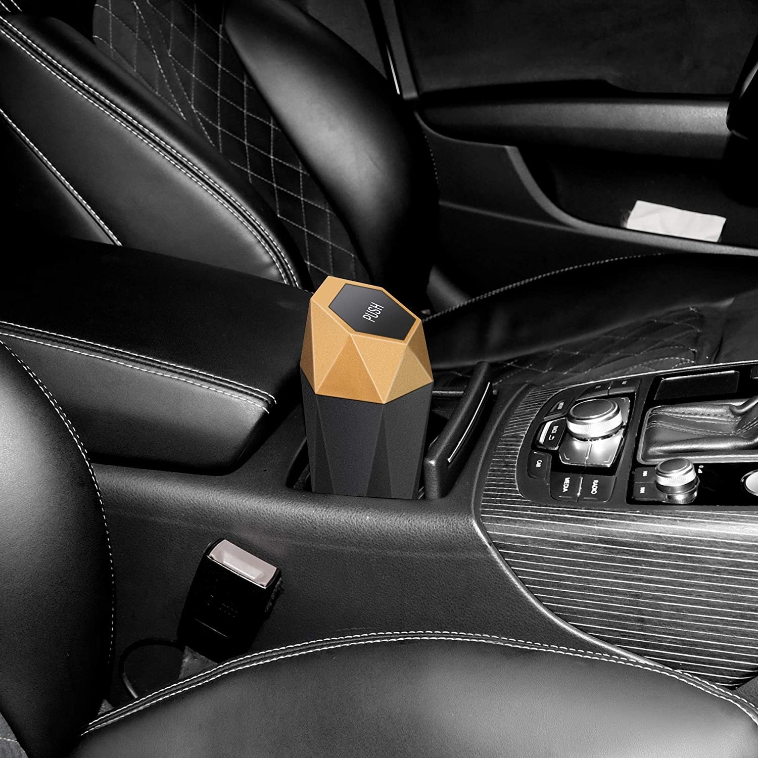 The mini trash can with geometric design sitting in the car&#x27;s cup holders 
