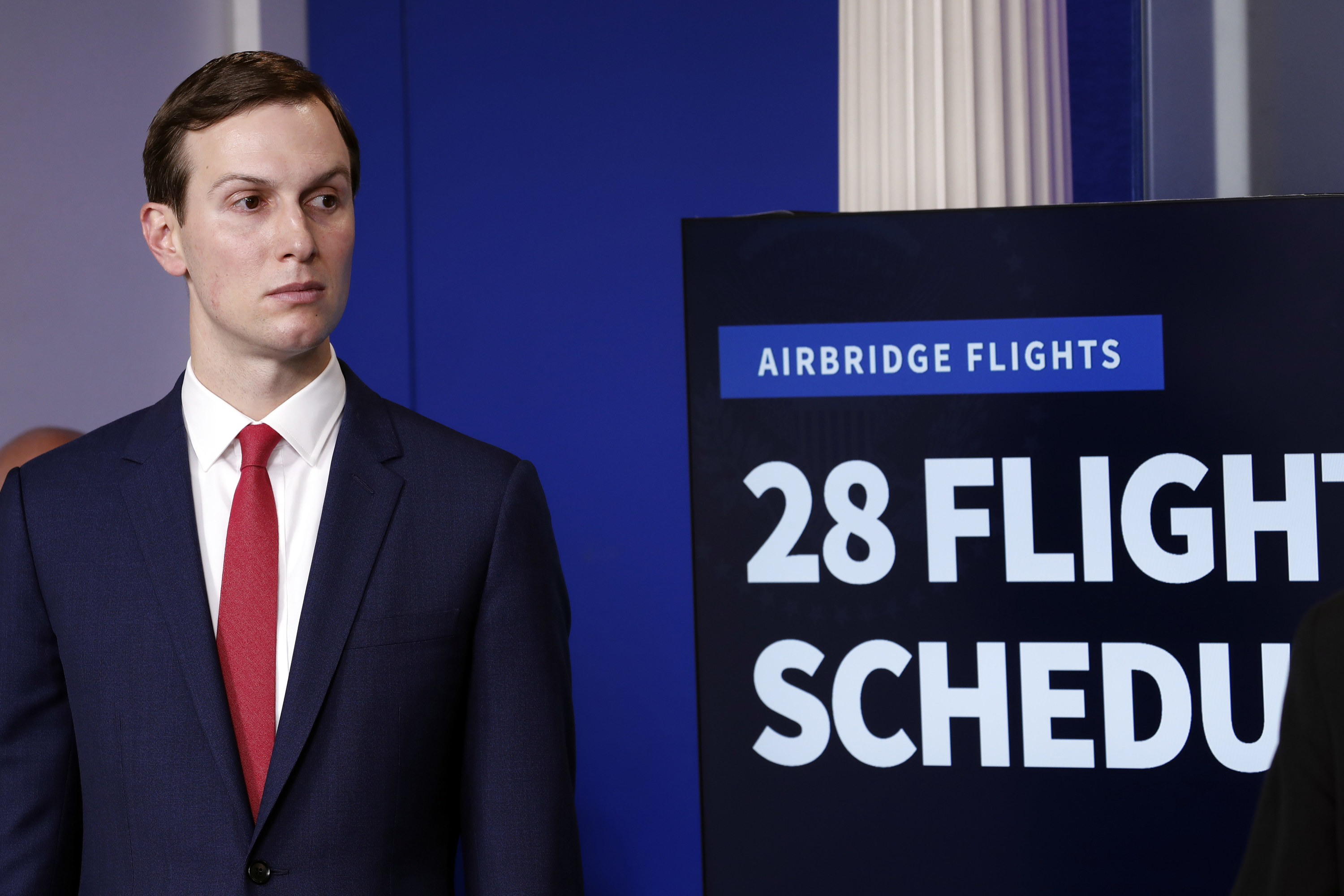 Jared Kusher stands in front of a monitor that reads &quot;Airbridge Flights: 28 Flights Scheduled&quot;