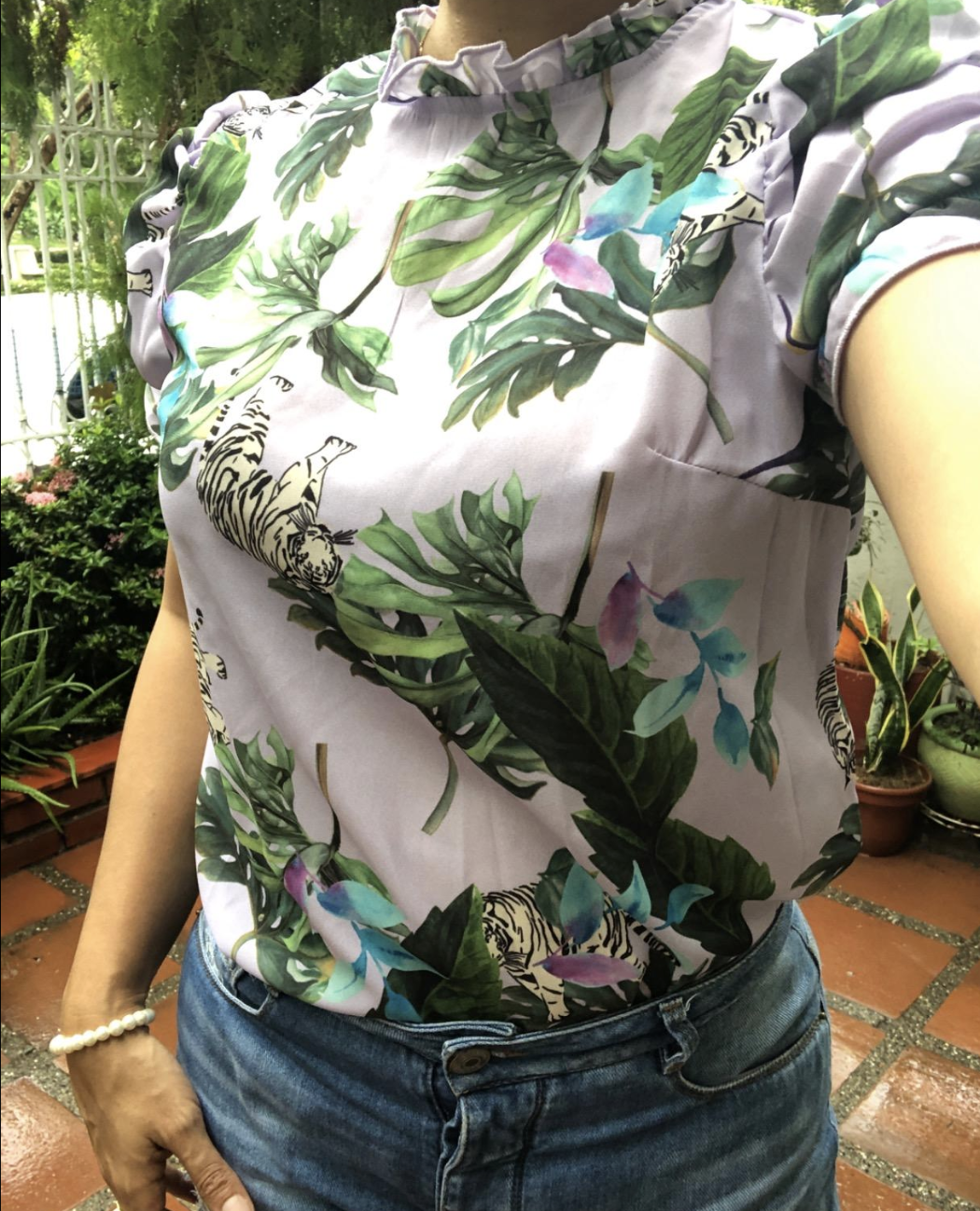 reviewer wearing the pink top with green florals