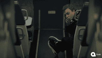 Dane DeHaan as Carl E. in &quot;The Stranger&quot; blowing a kiss while sitting on an empty bus