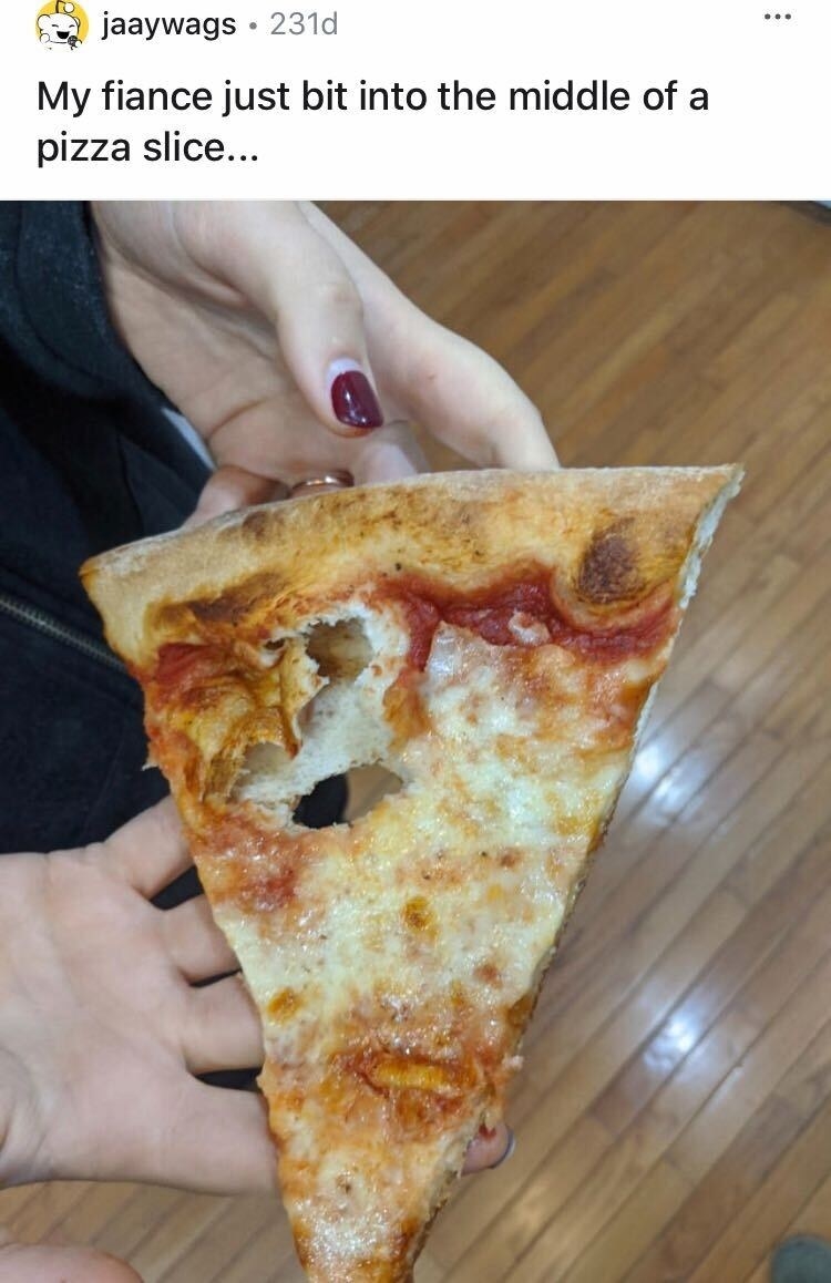 A pizza with a bite taken from the middle of it