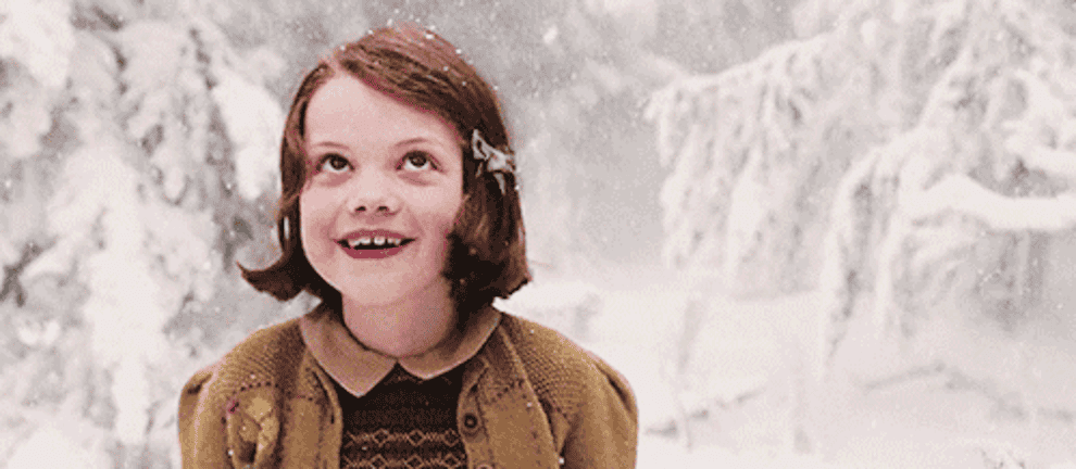 Gif of Lucy happily exploring the snowy woods of Narnia  