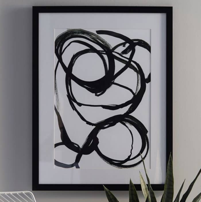 The modern black and white painting framed and hung
