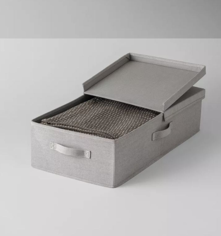 A gray fabric bin with a lid that folds over halfway