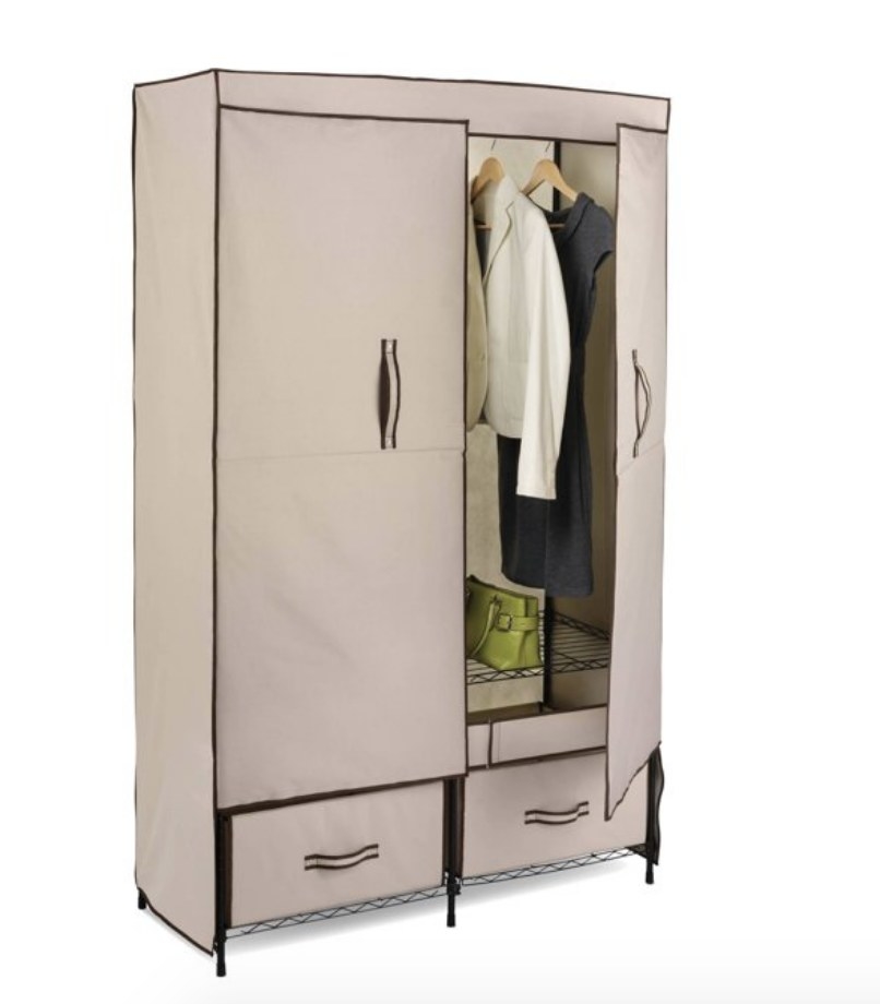 A light tan colored storage wardrobe with one door open revealing the black metal shelf inside
