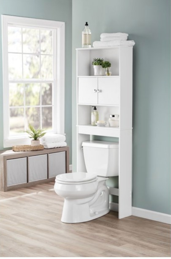 A white storage cabinet with shelves and cabinets positioned over a toilet 
