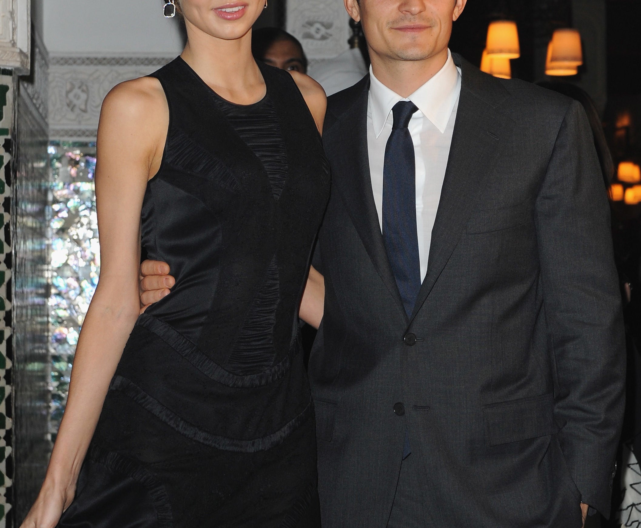 Miranda Kerr in a black gown and Orlando Bloom in dark grey suit and navy tie at an even in 2009.