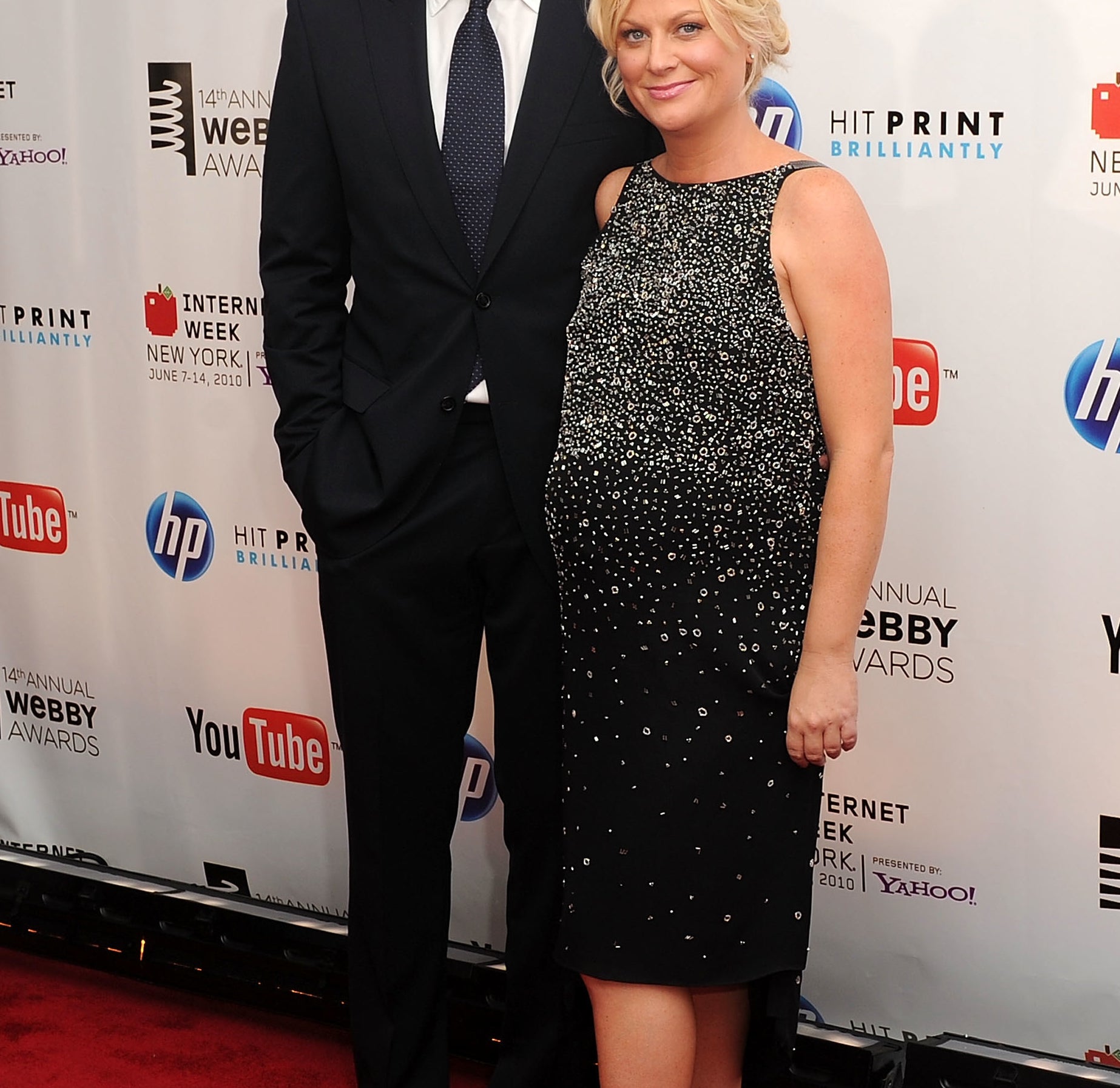 Will Arnett and Amy Poehler (who is pregnant and wearing a black stoned cocktail dress) on the red carpet of the 14th Annual Webby Awards in 2010