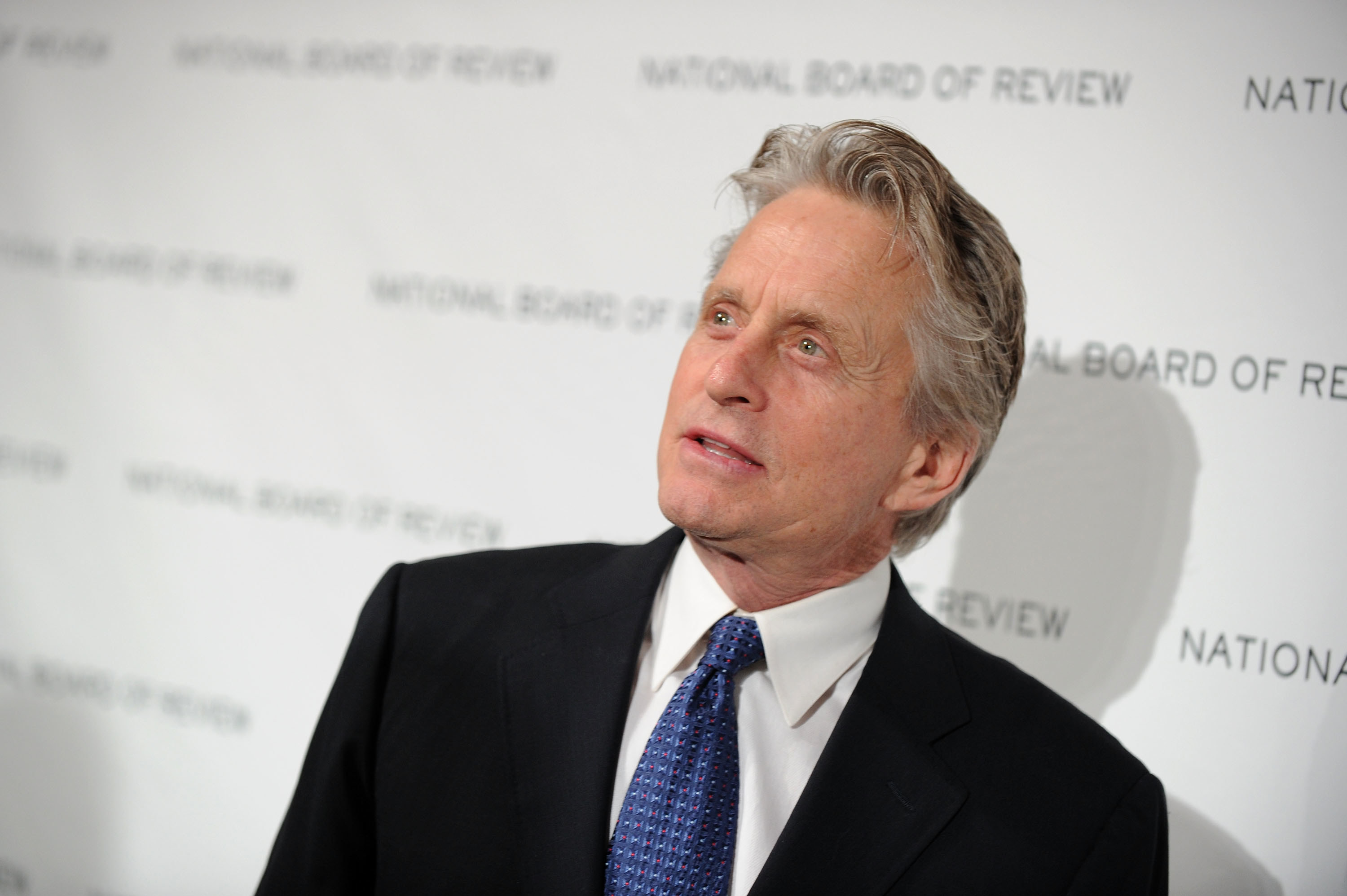  Michael Douglas attending the National Board of Review of Motion Pictures Awards gala in a black suit and blue tie in January 2010.