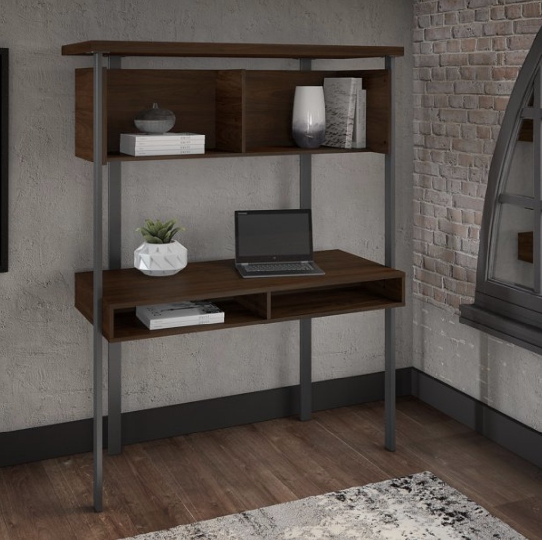 The tall two-tier dark wooden desk with desk storage on the bottom and two open shelves on top 
