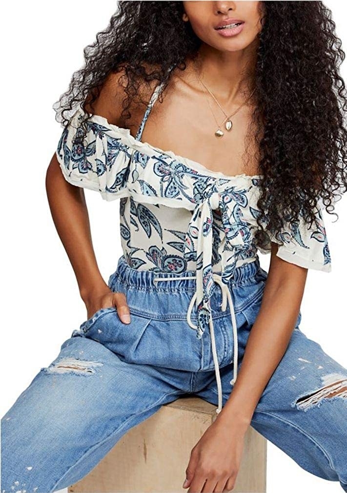 model wearing white and blue off shoulder top