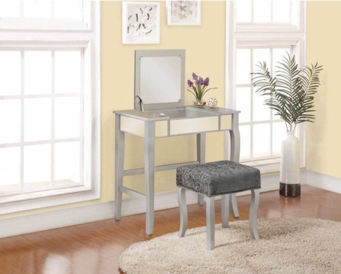 The mirrored vanity table set with grey velvet-y stool 