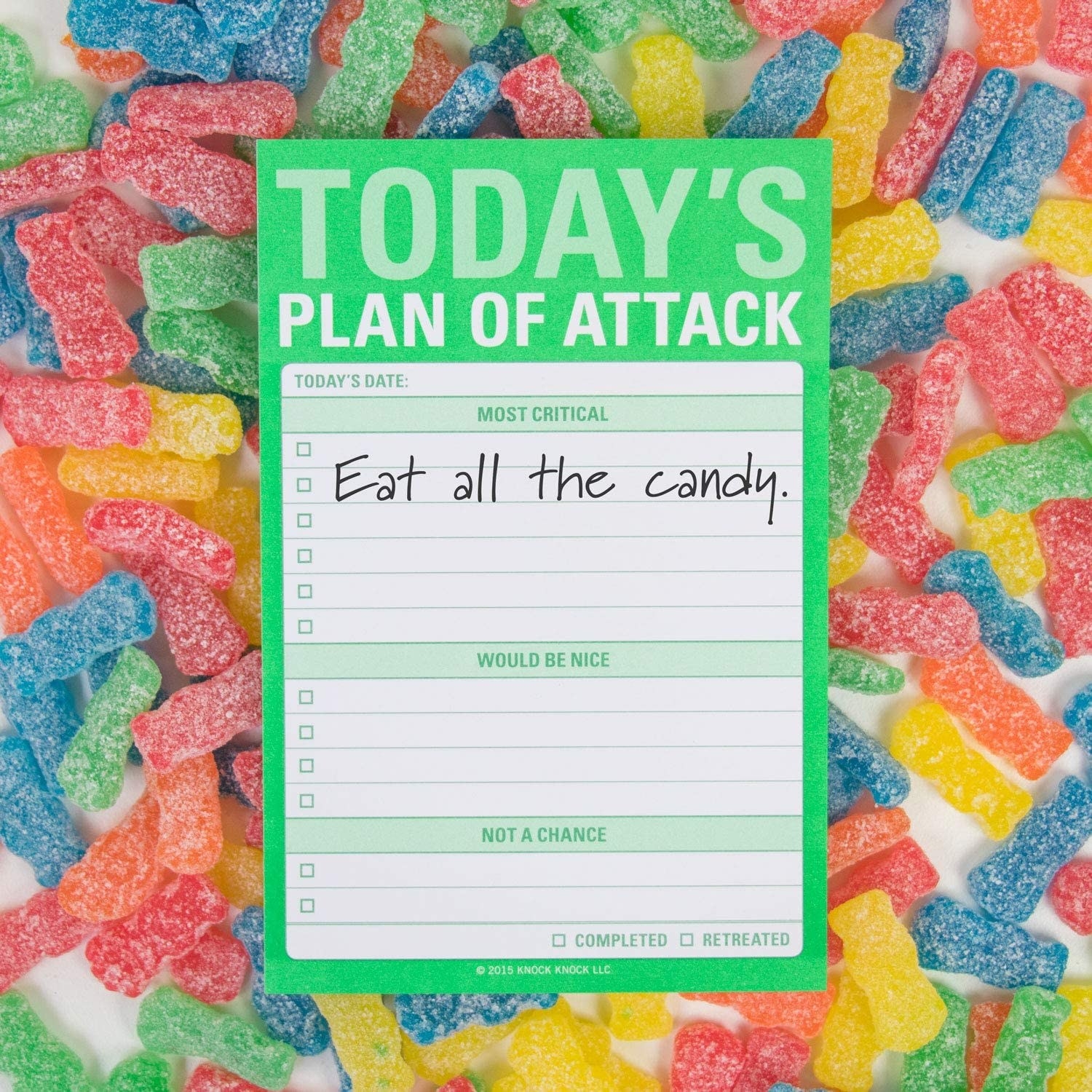 The to-do list sticky notepad on top of a pile of gummy bears