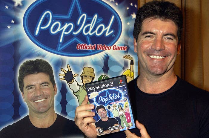 Simon Cowell holding the &quot;Pop Idol&quot; game with his own face plastered on it