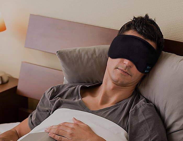 A man sleeps with the bluetooth sleep mask