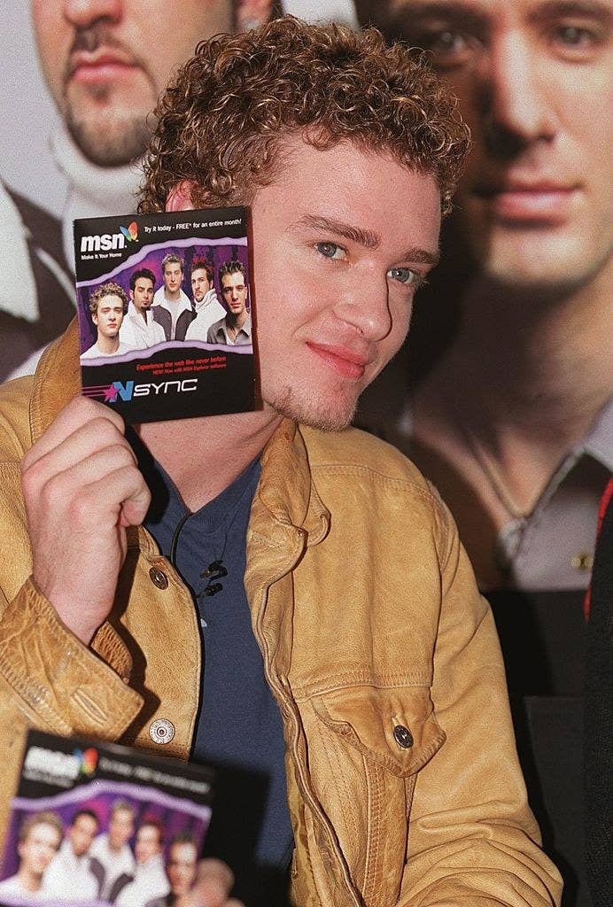 Justin Timberlake holding the NSYNC MSN CD 
