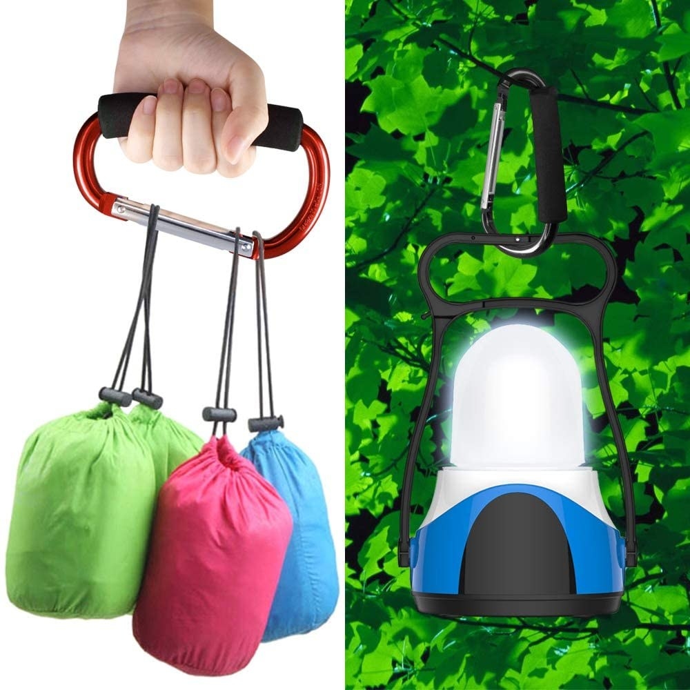 A cushioned carabiner being used to carry several bags and also a lantern