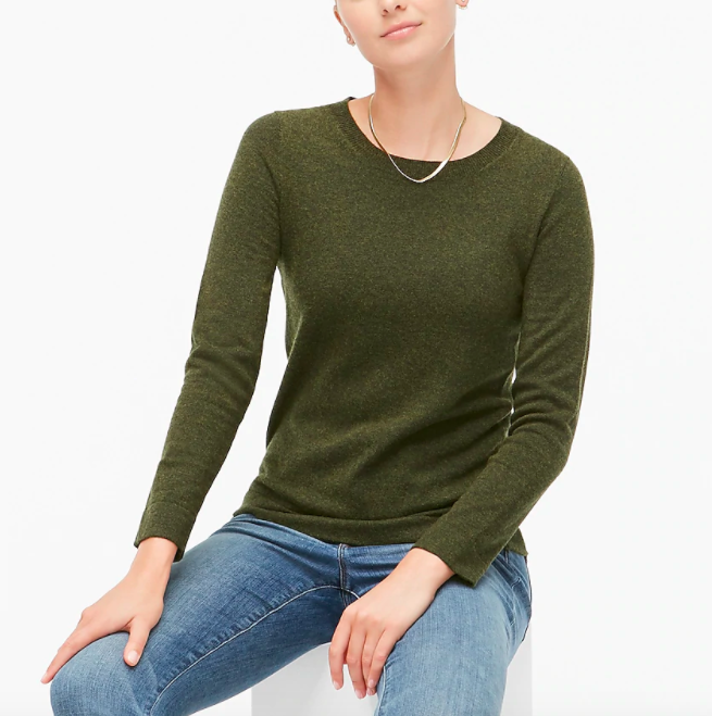 A model wearing the sweater in green 