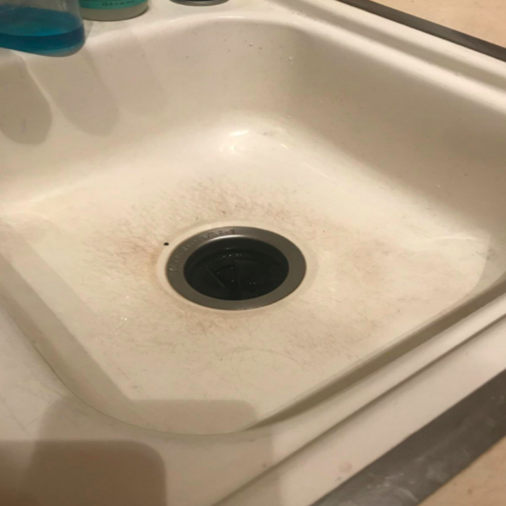 Reviewer photo showing their kitchen sink stained and scratched on the bottom and around the drain