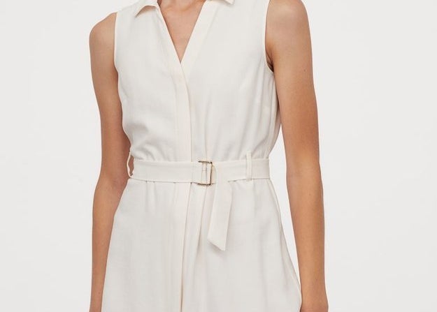 A sophisticated and collared dress that features a belted waist
