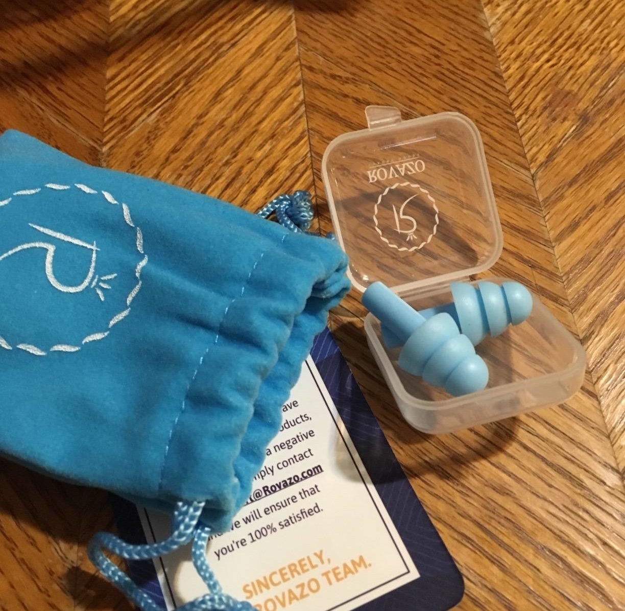 Reviewer&#x27;s photo of the blue earplugs in a plastic case 