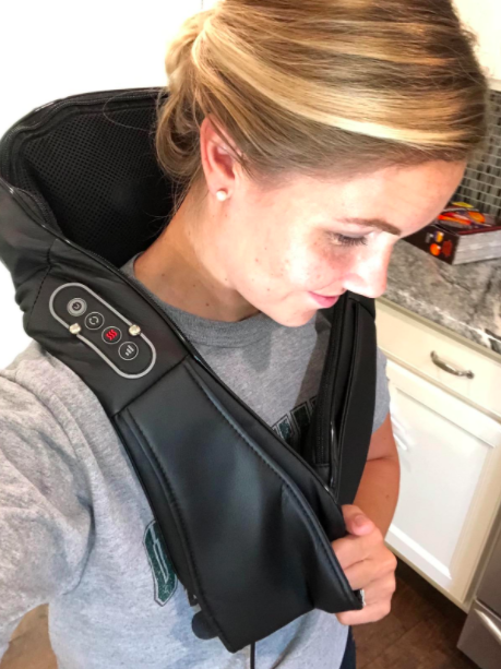 Reviewer photo demonstrating how the Naipo Shiatsu massager fits over the shoulders