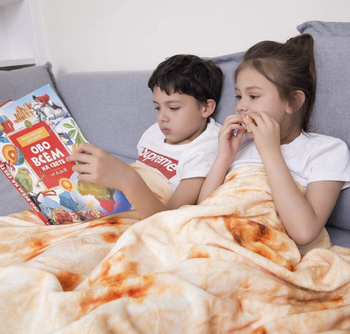 Two kids under the blanket reading 