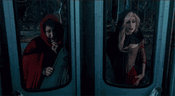 a gif of the sanderson sisters opening bus doors