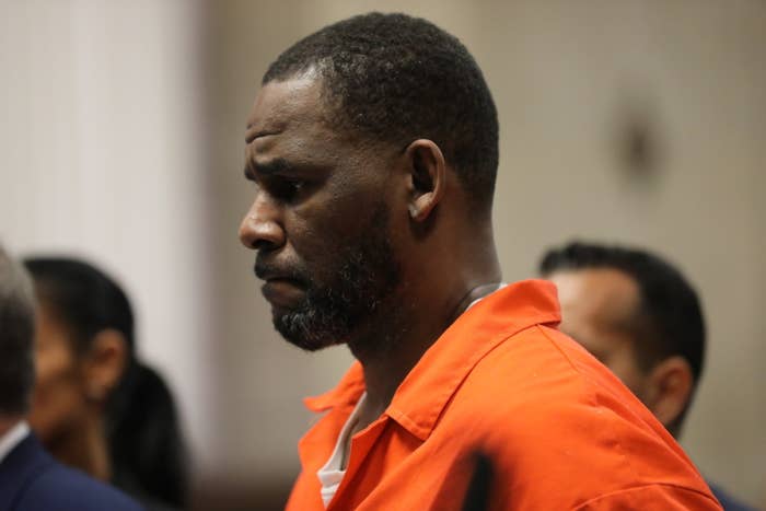 R. Kelly grimaces as he wears a prison uniform while in court