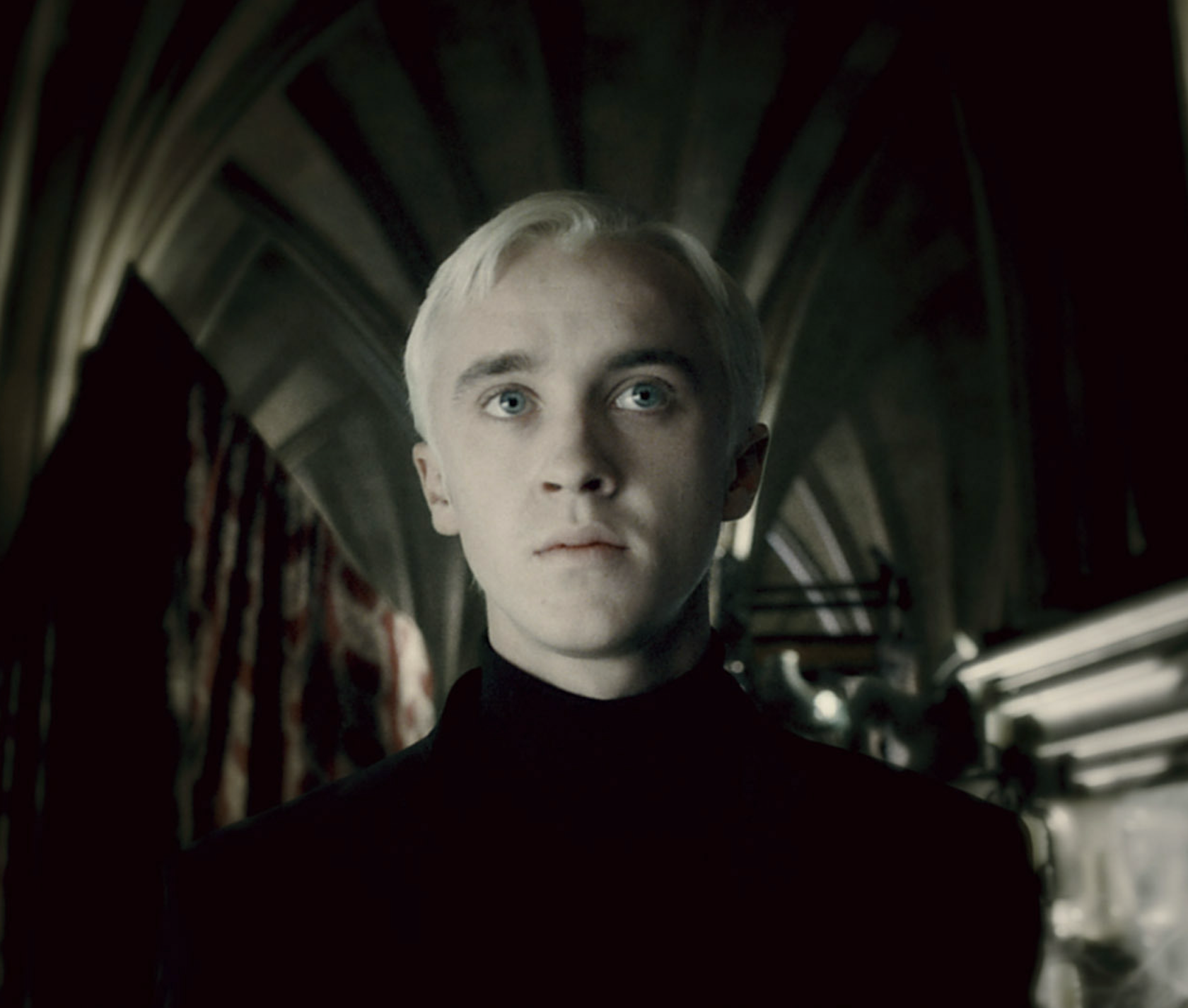 Draco standing in the Room of Requirement