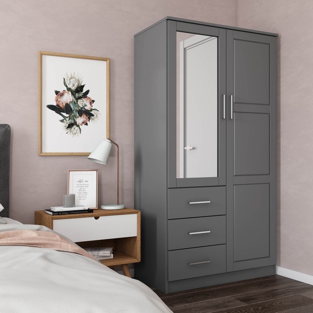 The large wardrobe with a mirror and three drawers under one side; the other side is full length