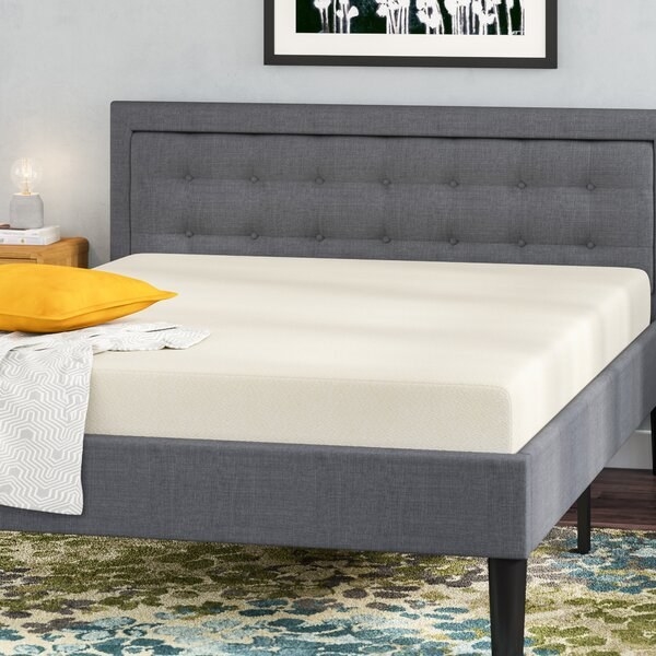 A thick and soft mattress on top of a bed frame 