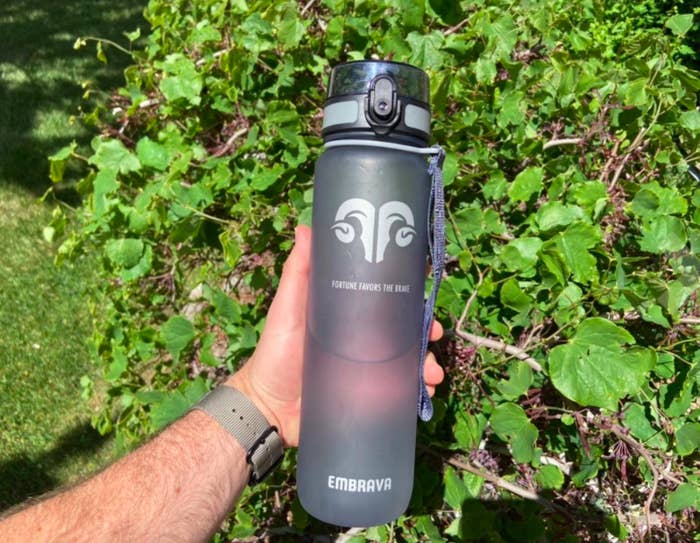 Reviewer photo of the reviewer holding the Embrava water bottle comfortably with one hand. 