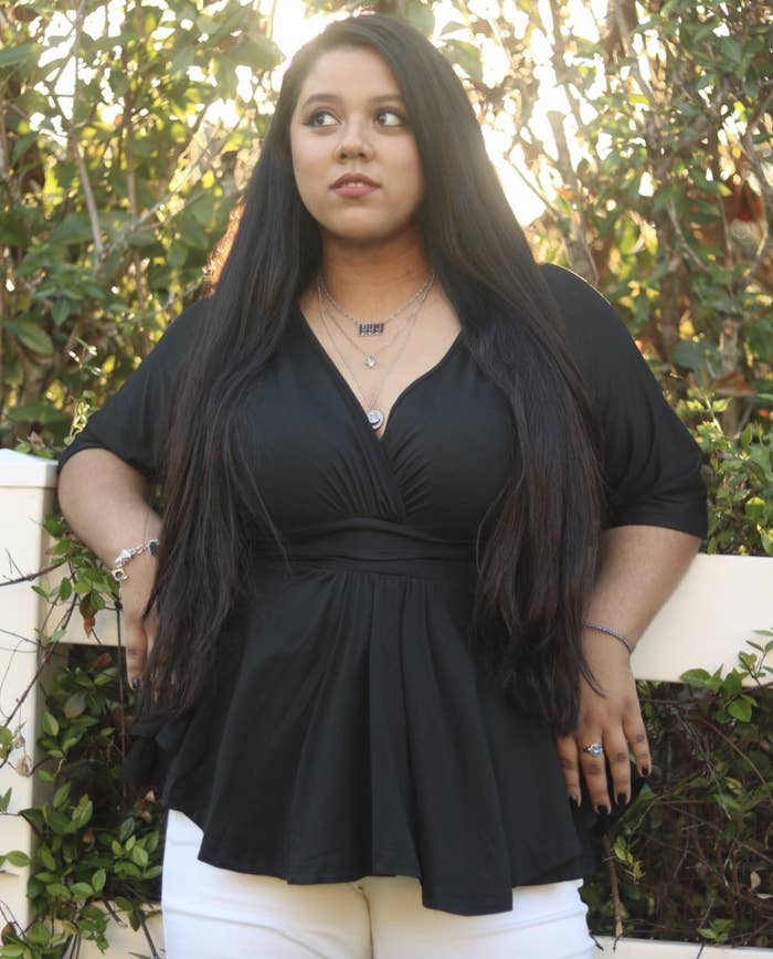 reviewer wearing black V-neck top