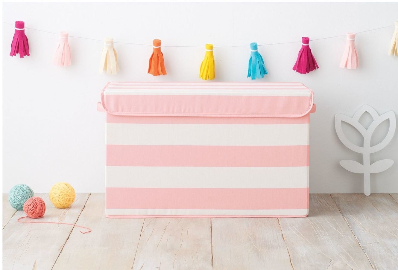 pink striped bin for storing toys