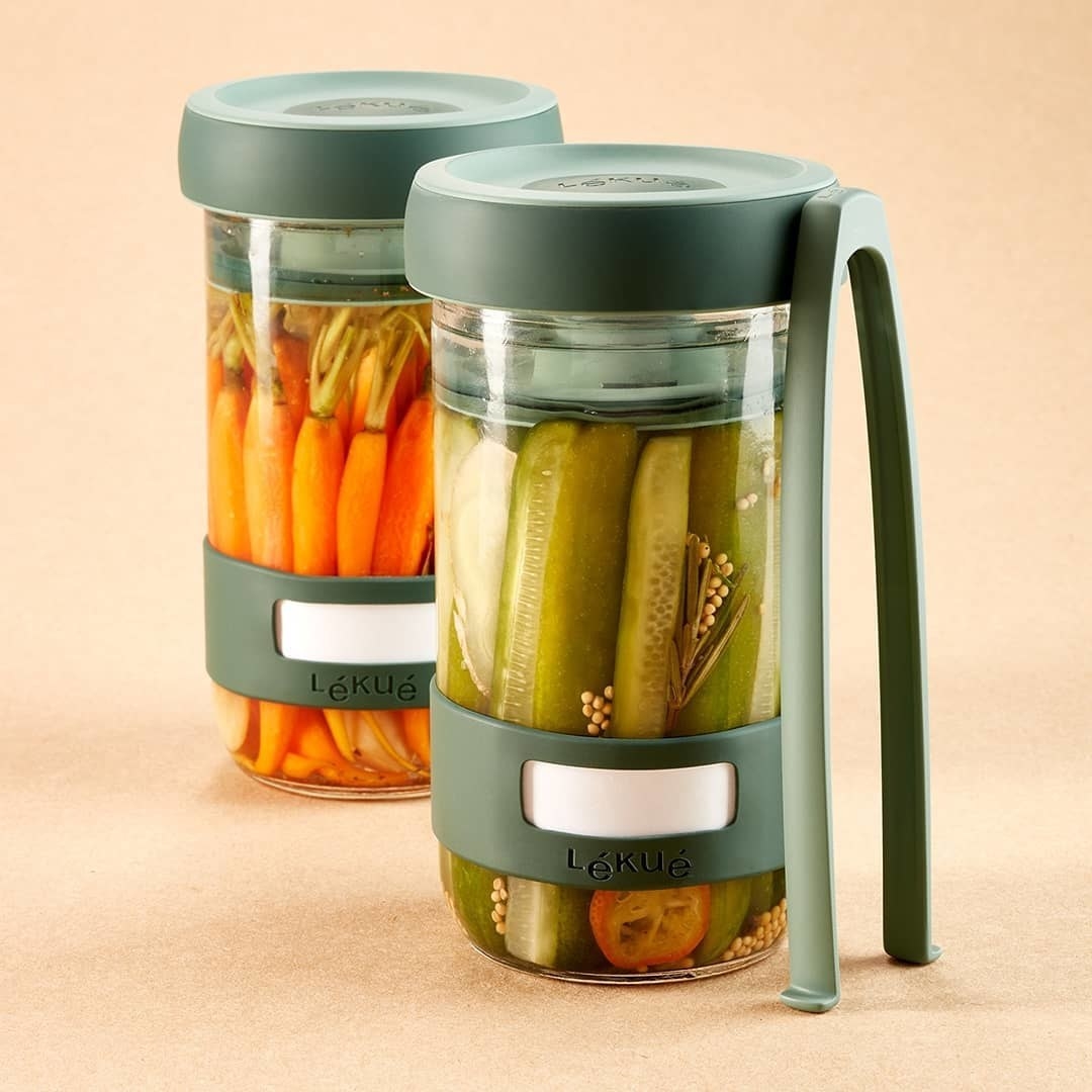 Two pickling containers filled with pickled veggies