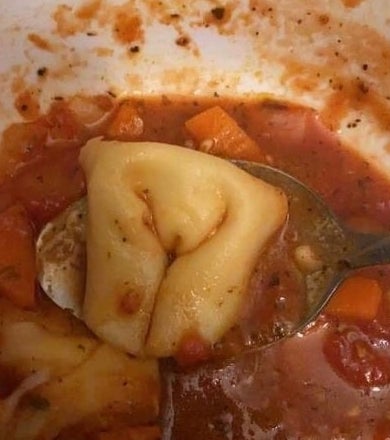 A piece of pasta with folds that look like legs and a vulva