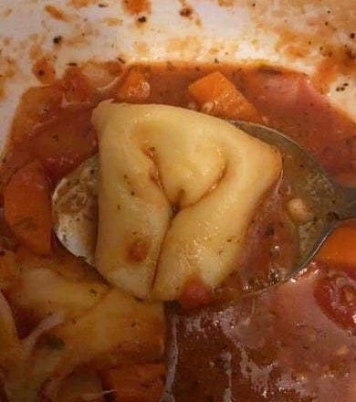 A piece of pasta with folds that look like legs and a vulva