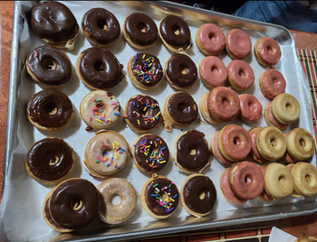 reviewer image of a sheet of donuts with different frostings on them 