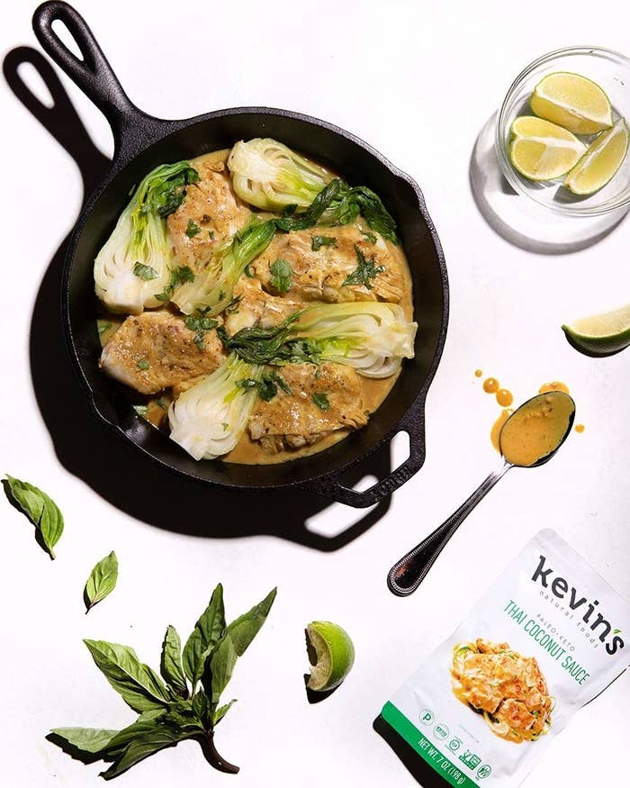 cast iron pan with the Thai Coconut Sauce cooking with chicken and bok choy