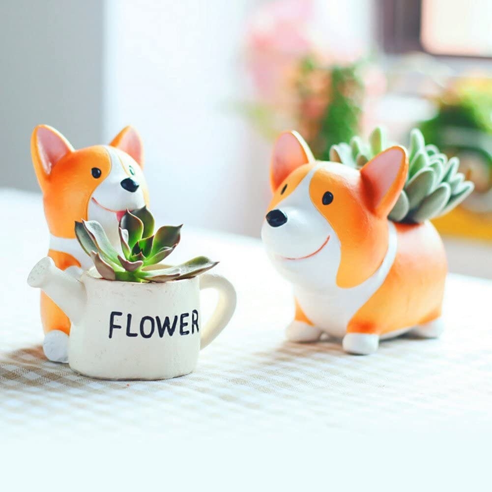 two corgi planters with succulents in their backs 