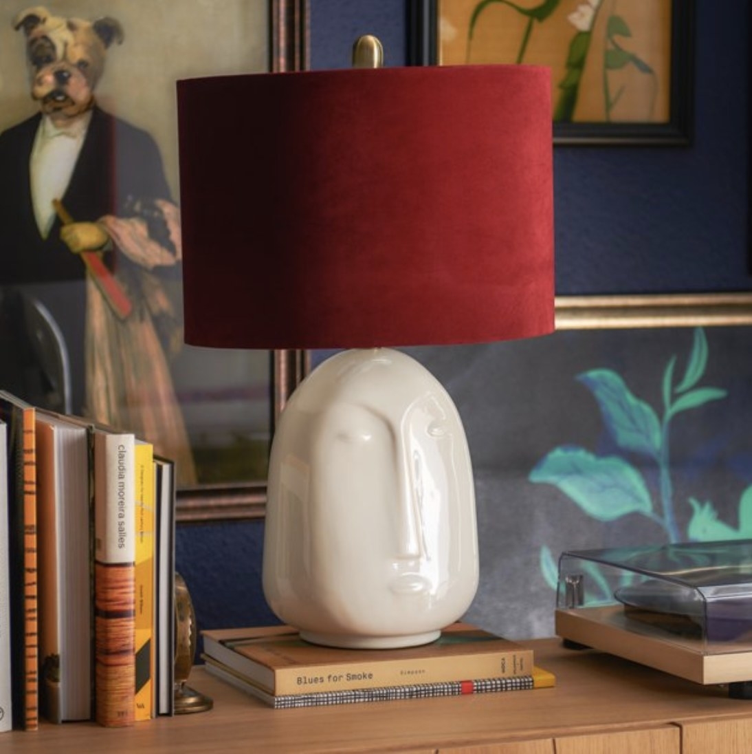 The lamp with red velvet shade and marble-like stand with face design 