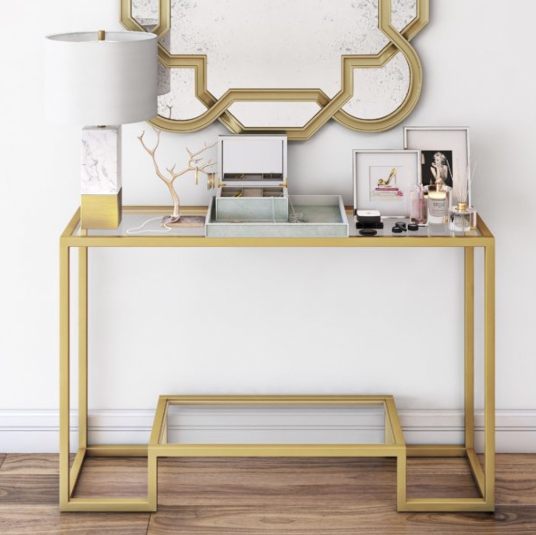 The gold geometric console table with glass top 