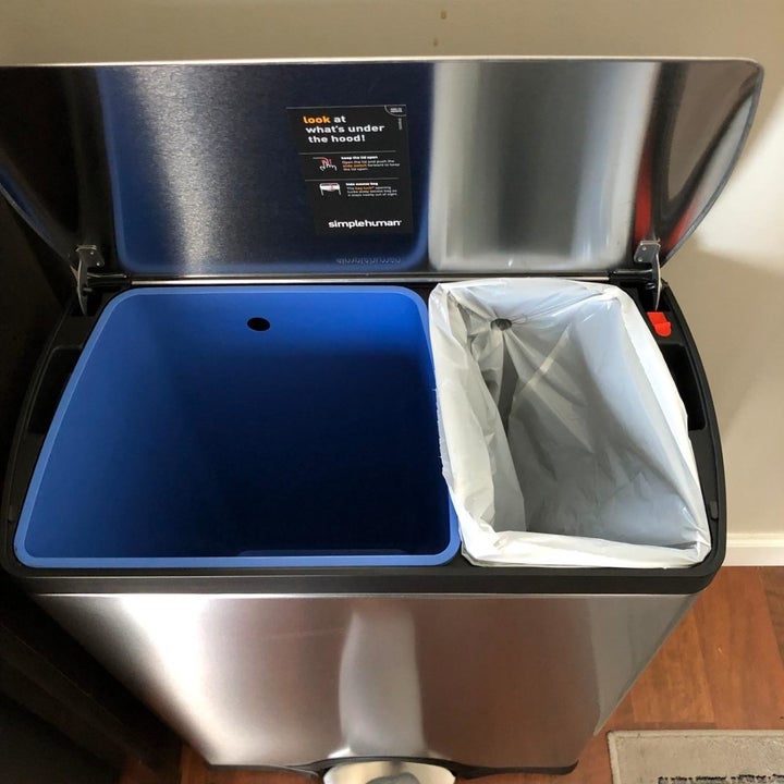 Split garbage and recycling bins inside open trash can