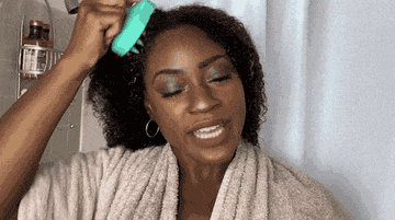 A gif of Carolina and Vivian testing out the scalp brush.