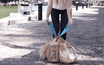 A gif of a person tying the carrier to their shopping bags